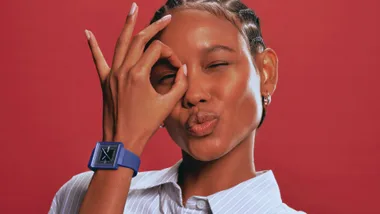 Woman wearing a swatch watch from the essentials range.