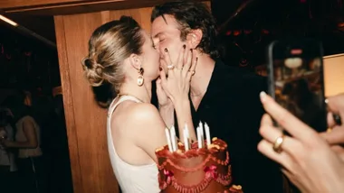 Gigi Hadid and partner, Bradley Cooper, kissing at her 30th birthday party.
