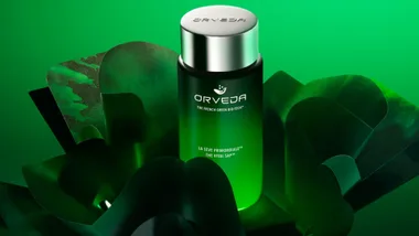 Orveda skincare product in a green bottle with a silver cap, set against a green background.