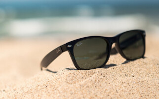 black sunglasses in the sand