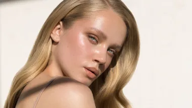 A blonde woman with glowing skin